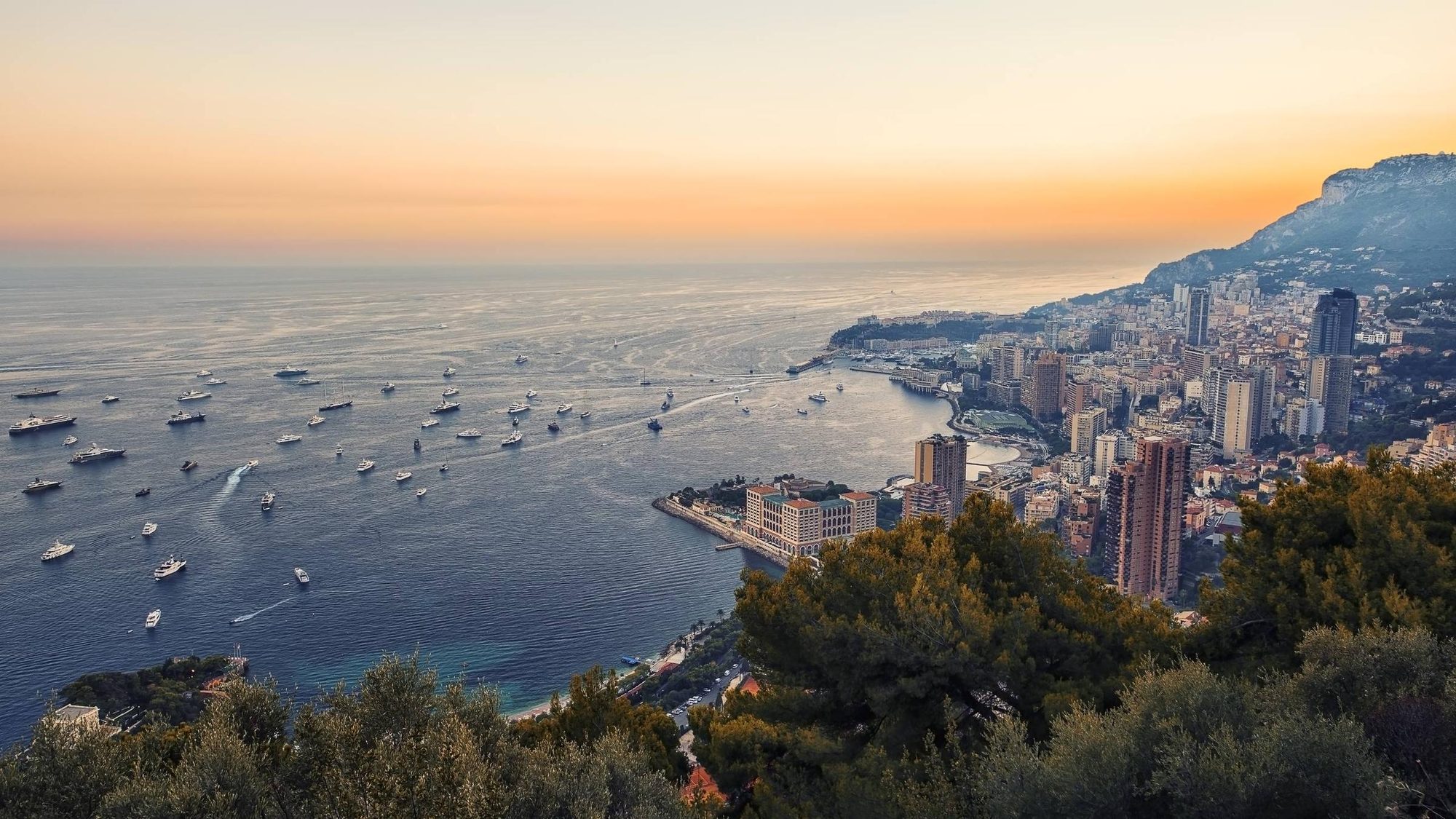 The coast at Monaco at dusk, the fleet lying at anchor offshore
